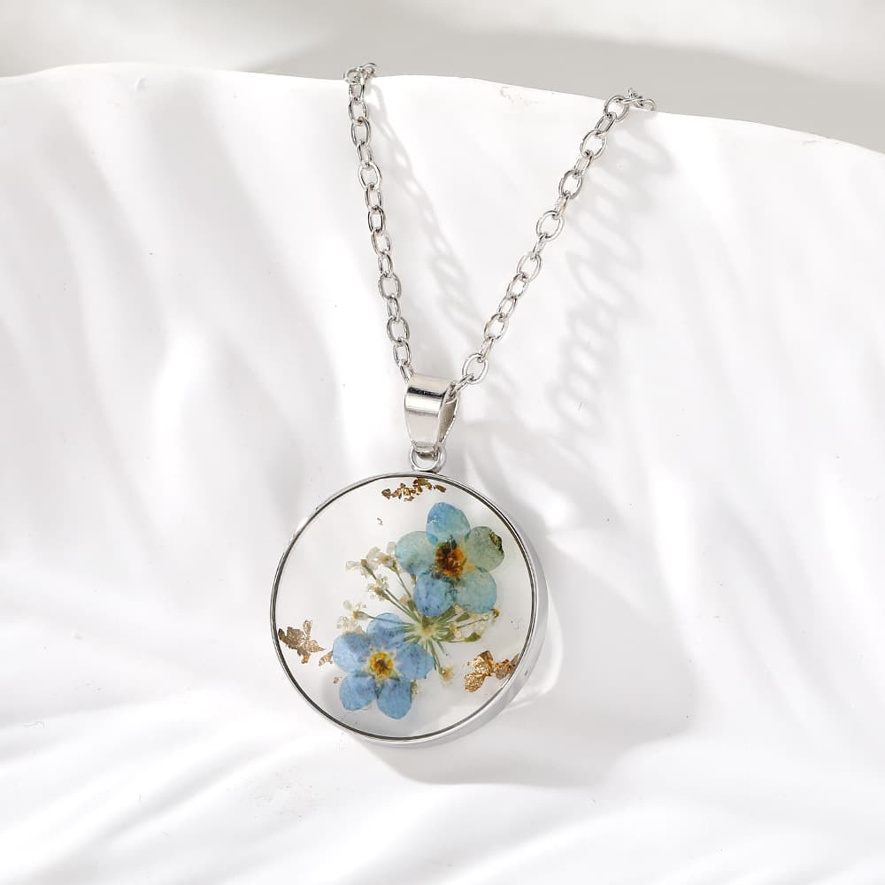 Conjunto de collar y aretes de flores en resina epoxi transparente