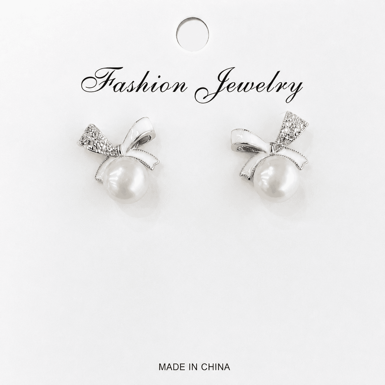 Aretes de perla con moño y circonia