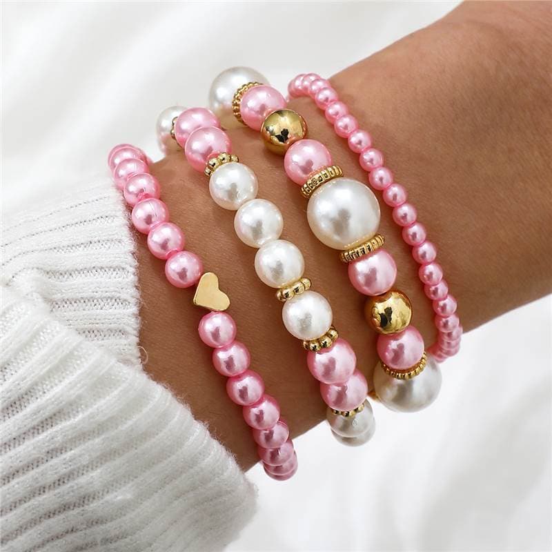 Set de 4 pulseras de perlas falsas con corazones