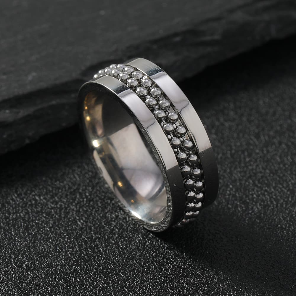 Anillo para parejas de acero inoxidable giratoria