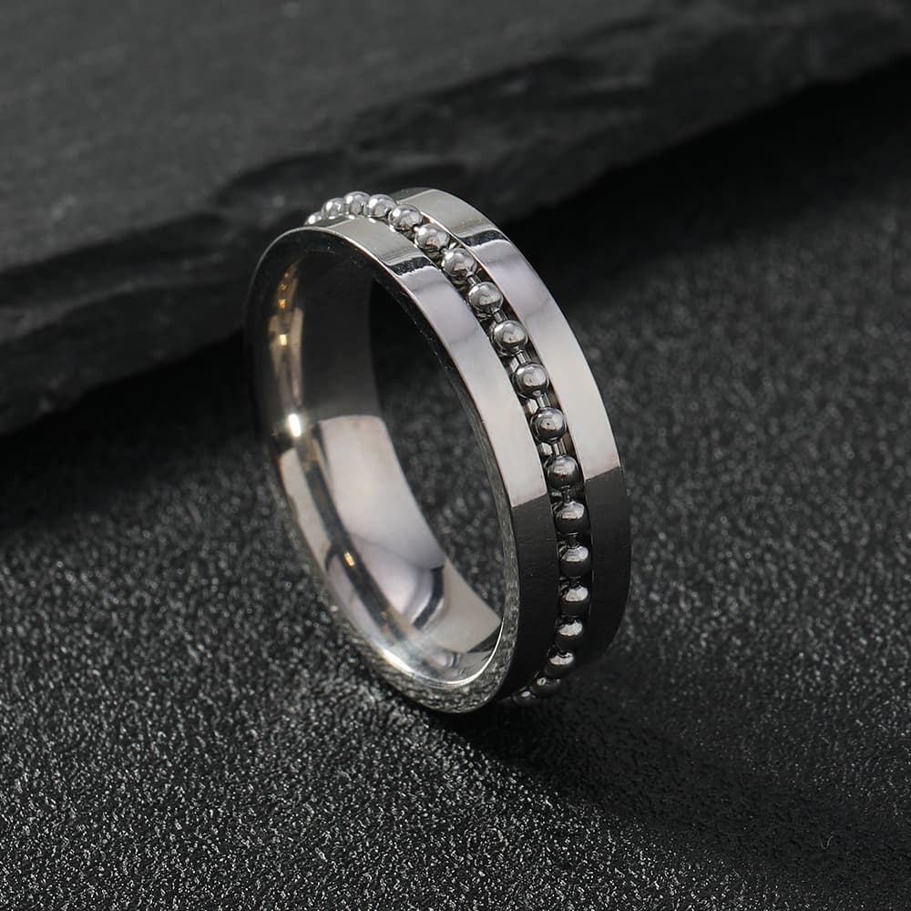 Anillo para parejas de acero inoxidable giratoria