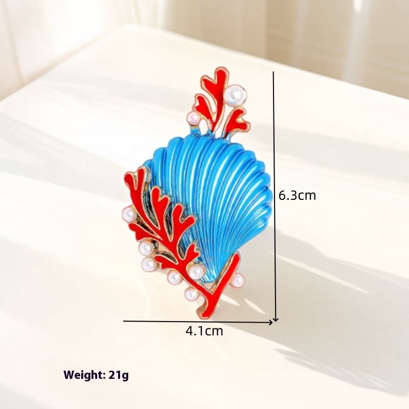 Broche de coral y concha marina en azul y blanco