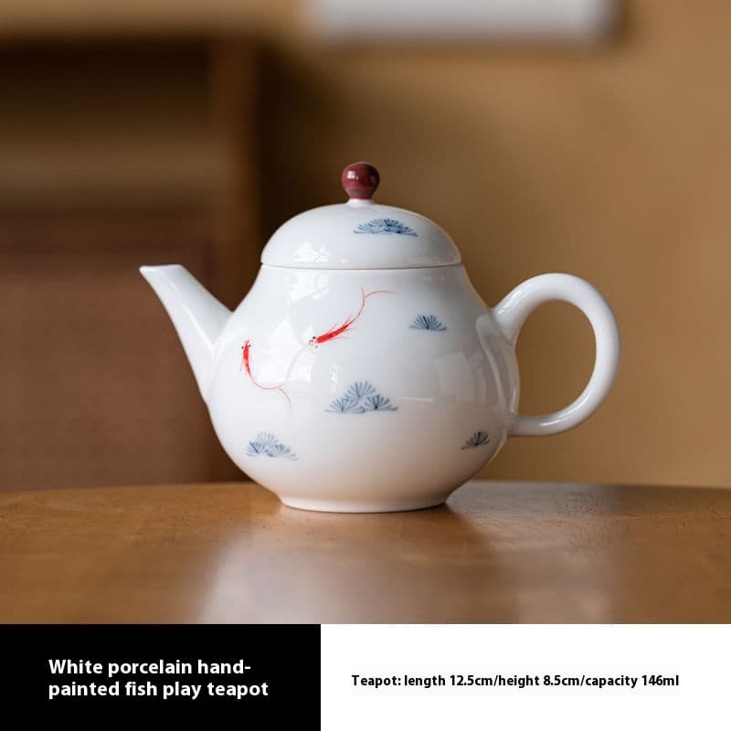 Tetera de porcelana blanca con peces pintados a mano