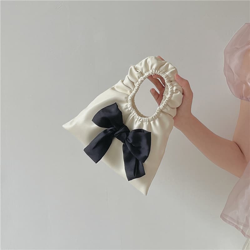 Mini bolsa plisada con moño para mujer