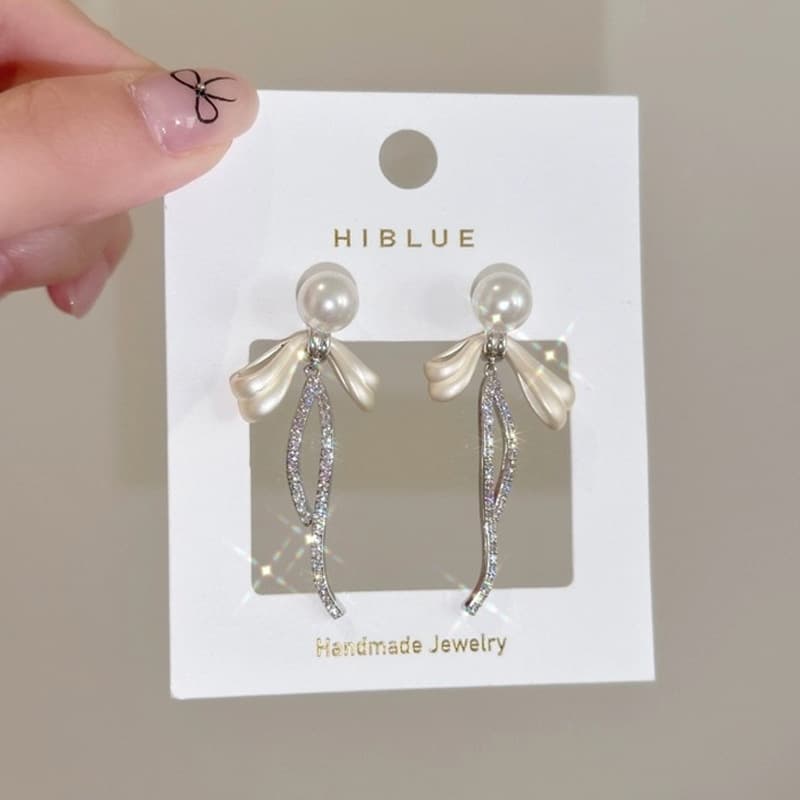 Aretes de botón azul marino con borla y moño