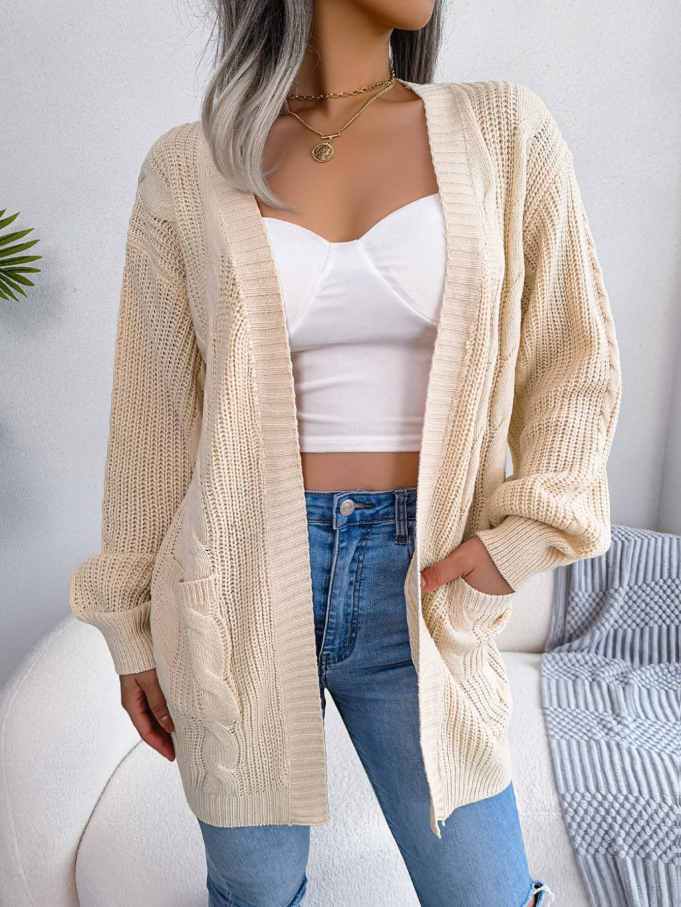 Cardigan de punto trenzado con mangas farol y bolsillos